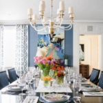 A dining room filled with furniture and vase of flowers on a table