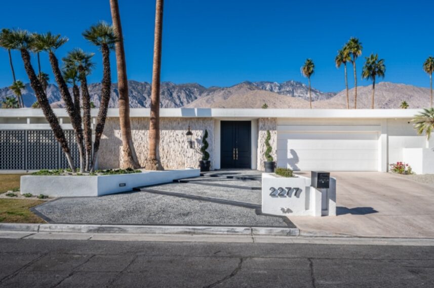 A palm tree in front of a building