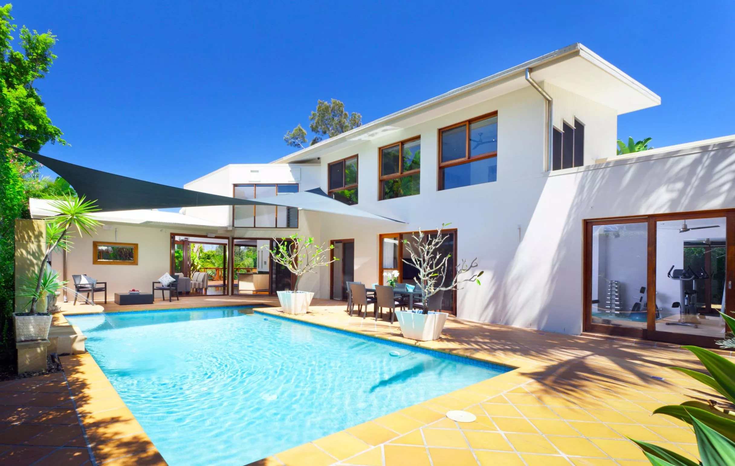 A house with a pool in front of a building